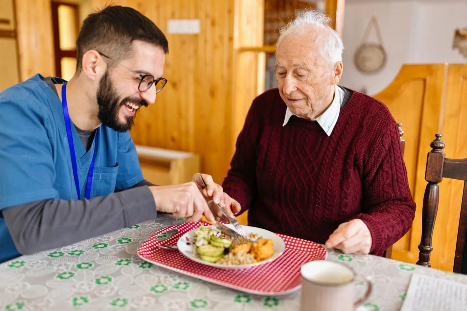 Caregiver sharing a meal with a senior