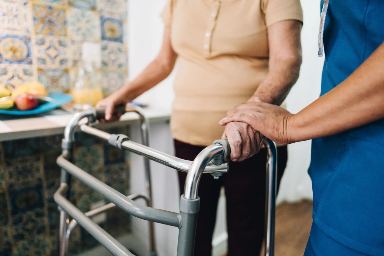 Caregiver helping a senior walk safely at home
